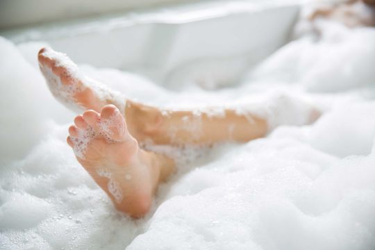 Feet poking out of warm bubble bath. Ben Todd Plumbing and Heating